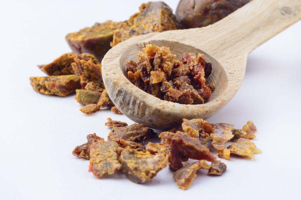 Photo a a wooden spoon and small pieces of propolis.